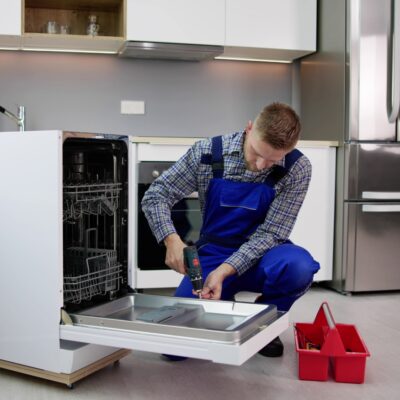 Professional plumber providing appliance installation in London, ensuring secure and leak-free washing machine fitting.